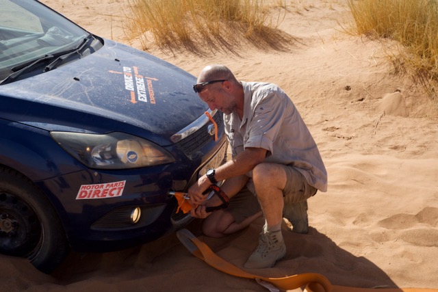 Preparing to tow one of the cars from deep sand